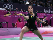 India`s Saina Nehwal plays against Belgium`s Lianne Tan, unseen, at a woman`s singles badminton match of the 2012 Summer Olympics.
