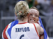 Britain`s Jennifer Taylor (6) and teammate Lynne Beattie hug after their team defeated Algeria in a women`s preliminary volleyball match at the 2012 Summer Olympics.