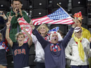Fans cheer for the United States during a beach volleyball match against the Czech Republic at the 2012 Summer Olympics.