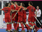 Belgian players celebrate their goal against Germany during their men`s hockey preliminary match at the 2012 Summer Olympics.