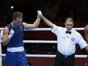 Germany`s Enrico Kolling, left, reacts after defeating Cameroon`s Christian Donfack Adjoufack in a men`s light heavy 81-kg boxing match at the 2012 Summer Olympics.