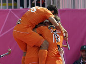 The Netherlands` Valentin Verga (26) jumps on top of his teammates, including Roderick Weusthof, shortly after scoring a goal in the men`s hockey preliminary match against India at the 2012 Summer Olympics.