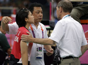 Head badminton referee Torsten Berg talks to Indonesia`s Greysia Polii and her coach Paulus Firman, after he showed a black card to players in the women`s doubles badminton match in London.