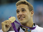 South Africa`s Chad le Clos poses with his gold medal for the men`s 200-meter butterfly swimming final at the Aquatics Centre in the Olympic Park during the 2012 Summer Olympics in London.