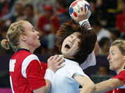 South Korea`s Jo Hyo-bi, center is tackled by Norway`s Karoline Dyhre Breivang, left, and Lynn-Kristin Koren, right, during their women`s handball preliminary match at the 2012 Summer Olympics in London.