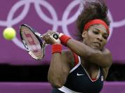 Serena Williams of the United States returns to Vera Zvonareva of Russia at the All England Lawn Tennis Club in Wimbledon, London at the 2012 Summer Olympics.