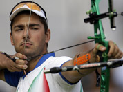 Italy`s Mauro Nespoli shoots during an elimination round of the individual archery competition at the 2012 Summer Olympics in London. 