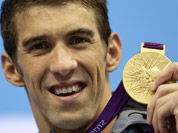 United States` Michael Phelps poses with his medal for the men`s 4x200-meter freestyle relay swimming final at the Aquatics Centre in the Olympic Park during the 2012 Summer Olympics in London.
