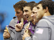 United States` Michael Phelps, center, pose with their gold medals after their win in the men`s 4 x 200-meter freestyle relay at the Aquatics Centre in the Olympic Park during the 2012 Summer Olympics in London.