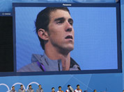 United States` Michael Phelps is seen on a large screen during a medal ceremony for the French, United States and Chinese men`s relay teams in the 4 x 200-meter freestyle relay at the Aquatics Centre in the Olympic Park during the 2012 Summer Olympics in London.