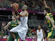 France`s Tony Parker drives to the basket past Lithuania`s Simas Jasaitis during a men`s basketball game at the 2012 Summer Olympics.
