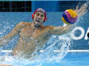 Nikolay Maximov of Kazakhstan makes a save on a shot by Greece during a preliminary men`s water polo match at the 2012 Summer Olympics.