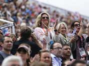 Ann Romney, left, the wife of U.S. Republican presidential candidate Mitt Romney applauses after her co-owned horse Rafalca attends in the equestrian dressage competition, at the 2012 Summer Olympics.