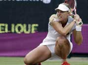 Angelique Kerber of Germany returns to Victoria Azarenka of Belarus at the All England Lawn Tennis Club in Wimbledon, London at the 2012 Summer Olympics.