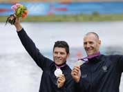 Italy`s Romano Battisti, left, and Alessio Sartori celebrate after winning the silver medal for the men`s rowing double sculls in Eton Dorney, near Windsor, England, at the 2012 Summer Olympics.