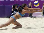 Marta Menegatti of Italy digs out a ball during a beach volleyball match against Canada at the 2012 Summer Olympics.