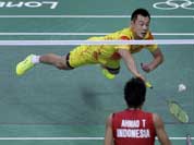 China`s Xu Chen dives to return a shuttle while playing against Indonesia`s Tontowi Ahmad, and Liliyana Natsir, unseen, at a mixed doubles badminton semifinal match of the 2012 Summer Olympics.