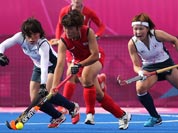 South Korea`s Park Mi-Hyun and Japan`s Yukari Yamamoto, vie for the ball as Japan`s Nagisa Hayashi, looks on in the women`s hockey preliminary round match at the 2012 Summer Olympics.