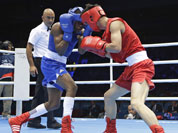 China`s Liu Qiang, right, fights Cuba`s Yashier Toledo Lopez during their men`s light 60-kg boxing match at the 2012 Summer Olympics.