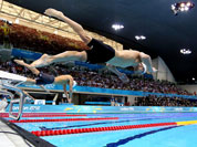 United States` Michael Phelps dives off the starting blocks in the men`s 100-meter butterfly swimming race at the 2012 Summer Olympics.