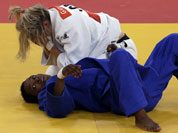 Gemma Gibbons of Great Britain reacts after winning her match against Audrey Tcheumeo of France during the women`s 78-kg judo competition at the 2012 Summer Olympics.