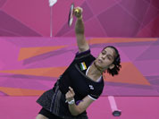 Saina Nehwal plays against Denmark`s Tine Baun, unseen, at a women`s singles badminton quarterfinal match of the 2012 Summer Olympics.