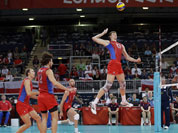 Russia`s Dmitriy Muserskiy (13) goes up for a spike against the Tunisia defense during a men`s volleyball preliminary match at the 2012 Summer Olympics.
