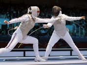 Britain`s Sophie Troiano faces Egypt`s Shaimaa Elgammal during a round of 16 match at women`s team foil fencing at the 2012 Summer Olympics.