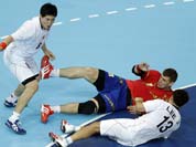Julen Aguinagalde of Spain, center, and Lee Jae-woo (13) and Park Jung-geu of South Korea challenge during their men`s handball preliminary match at the 2012 Summer Olympics.