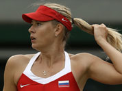 Maria Sharapova of Russia pulls her ponytail as she plays against Sabine Lisicki of Germany at the All England Lawn Tennis Club at Wimbledon, in London, at the 2012 Summer Olympics.