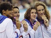 From right, France`s Camille Muffat, France`s Charlotte Bonnet, France`s Ophelie-Cyrielle Etienne and France`s Coralie Balmy pose with their bronze medals for the women`s 4x200-meter freestyle relay swimming final at the Aquatics Centre in the Olympic Park during the 2012 Summer Olympics.