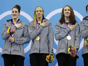 From left, United States` Missy Franklin, United States` Dana Vollmer, United States` Shannon Vreeland and United States` Allison Schmitt pose with their gold medals for the women`s 4x200-meter freestyle relay swimming final at the Aquatics Centre in the Olympic Park during the 2012 Summer Olympics.