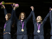 Italy`s gold medalists Elisa Di Francisca, left to right, Arianna Errigo, Valentina Vezzali and Ilaria Salvatori celebrate after defeating Russia in the gold medal match at women`s team foil fencing at the 2012 Summer Olympics.