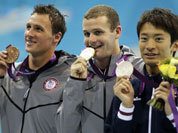 Japan`s Ryosuke Irie, United States` Tyler Clary and United States` Ryan Lochte pose with their medals for the men`s 200-meter backstroke swimming final at the Aquatics Centre in the Olympic Park during the 2012 Summer Olympics in London.