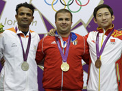 Gold medalist, Cuba`s Leuris Pupo, center poses for a picture with silver medalist, India`s Vijay Kumar, and bronze medalist, China`s Zhang Jian during the victory ceremony for the men`s 25-meter rapid fire pistol event at the 2012 Summer Olympics, in London. 