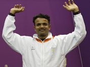 Vijay Kumar reacts as he mounts the medals podium to receive a silver for the men`s 25-meter rapid fire pistol event at the 2012 Summer Olympics in London.