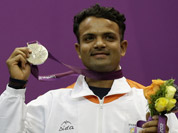Vijay Kumar reacts displays his silver medal, during the victory ceremony for the men`s 25-meter rapid fire pistol event at the 2012 Summer Olympics in London.