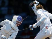 United States` Susie Scanlan, left, competes against Italy`s Nathalie Moellhausen during women`s team epee fencing at the 2012 Summer Olympics.