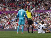 Egypt`s Saadeldin Saad, bottom right, is sent off by official Mark Geiger after a foul on Japan`s Manabu Saito, left, as Egypt`s goalkeeper Ahmed Elshenawi stands by during their quarter-final men`s soccer match at the London 2012 Summer Olympics.