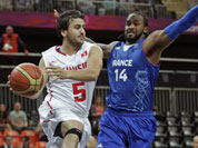 Tunisia`s Marouan Laghnej, looks to pass as he drives past France`s Ronny Turiaf during a men`s basketball game at the 2012 Summer Olympics in London. 