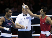 India`s Krishan Vikas, right, reacts after defeating the United States` Errol Spence during a men`s welterweight 69-kg preliminary boxing match at the 2012 Summer Olympics
