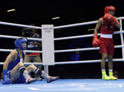 Devendro Singh Laishram of India, right, knocks down Serdamba Purevdorj of Mongolia, during their fight at the men`s light flyweight boxing at the 2012 Summer Olympics.