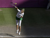 Victoria Azarenka of Belarus serves to Serena Williams of the United States at the All England Lawn Tennis Club in Wimbledon, London at the 2012 Summer Olympics.