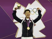 Gold medal winner, South Korea`s Jin Jong-oh, right, celebrates with countryman Choi Young-rae, who took silver, during the victory ceremony for the men`s 50-meter pistol, at the 2012 Summer Olympics.