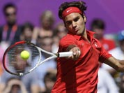 Switzerland`s Roger Federer returns a shot to Britain`s Andy Murray during the men`s singles gold medal match at the All England Lawn Tennis Club at Wimbledon, in London, at the 2012 Summer Olympics.