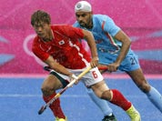 Sardar Singh, right and South Korea`s Lee Nam-yong vie for the ball their men`s hockey preliminary round match against Pakistan at the 2012 Summer Olympics.
