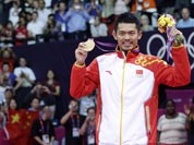 China`s Lin Dan, right, shows his gold medal after winning the men`s singles badminton gold medal match defeating Malaysia`s Lee Chong Wei, left, at the 2012 Summer Olympics.