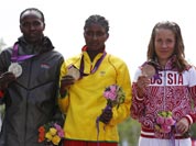 Ethiopia`s Tiki Gelana is flanked by Kenya`s silver medal winner Priscah Jeptoo, left, and Russia`s bronze medalist Tatyana Petrova Arkhipova during the ceremony for the women`s marathon at the 2012 Summer Olympics.