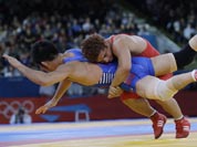 Cuba`s Gustavo Balart, right, takes South Korea`s Choi Gyu-jin to the mat 55-kg Greco-Roman wrestling competition at the 2012 Summer Olympics.