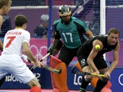 Belgium`s John-John Dohmen (7) tries to score a goal as New Zealand`s Bradley Shaw (12) defends during their men`s hockey preliminary match at the 2012 Summer Olympics.